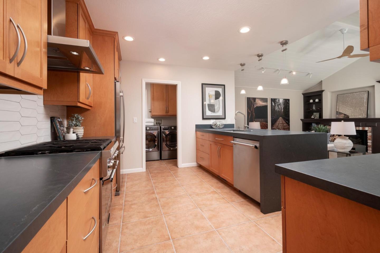 405 29th Avenue San Mateo, CA 94403 - Photo 8 of 22 a kitchen with stainless steel appliances kitchen island granite countertop a refrigerator and a stove top oven