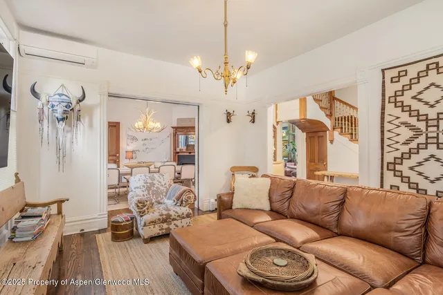 a living room with furniture a flat screen tv and a large window