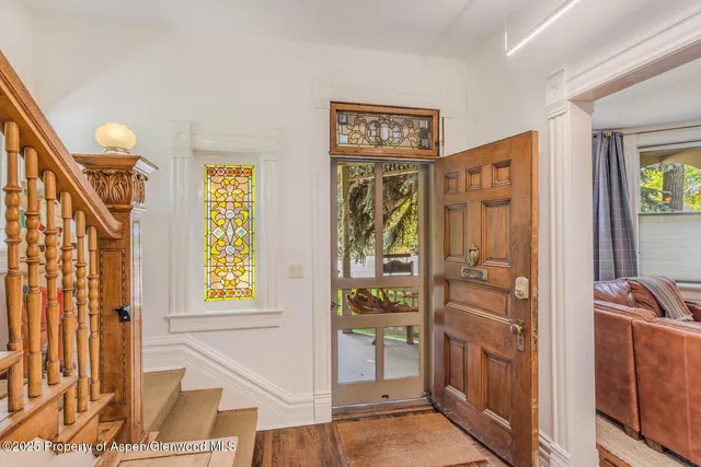 a front view of a house with a yard and potted plants