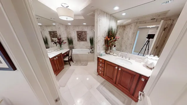 a living room with furniture fireplace and large windows