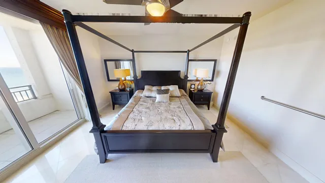 a spacious bedroom with a bed and a chandelier