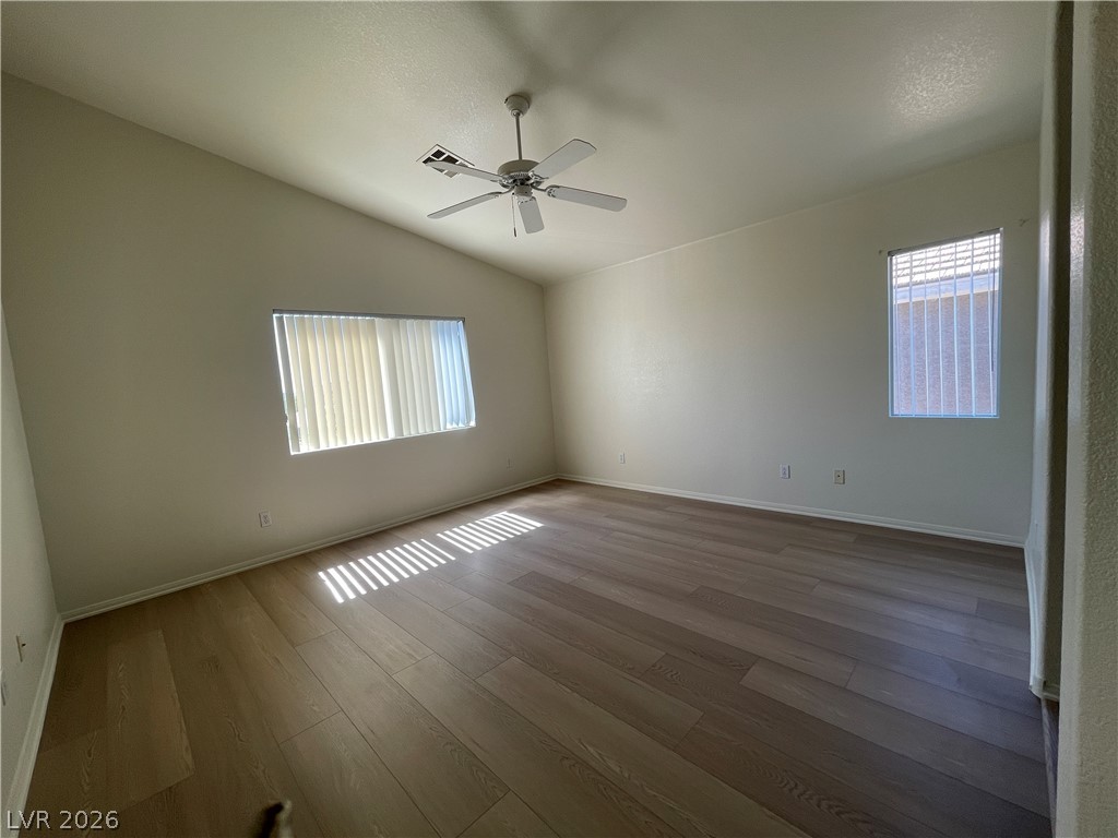 11049 Zarod Road Las Vegas, NV 89135 - Photo 13 of 17 Gleaming wood floors anchor this versatile room illuminated by natural light through dual windows.