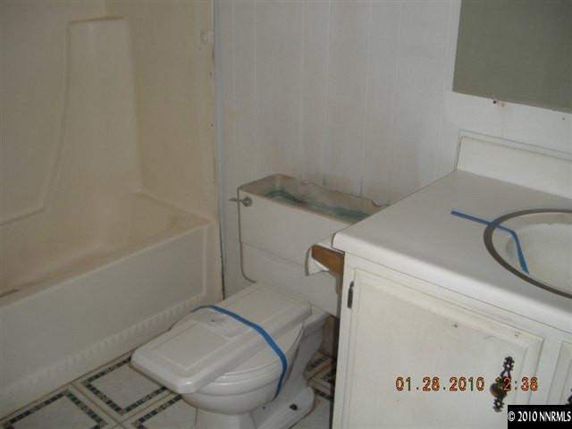 16085 Rhyolite Circle Reno, NV 89521 - Photo 8 of 9 a bathroom with a granite countertop toilet and a sink