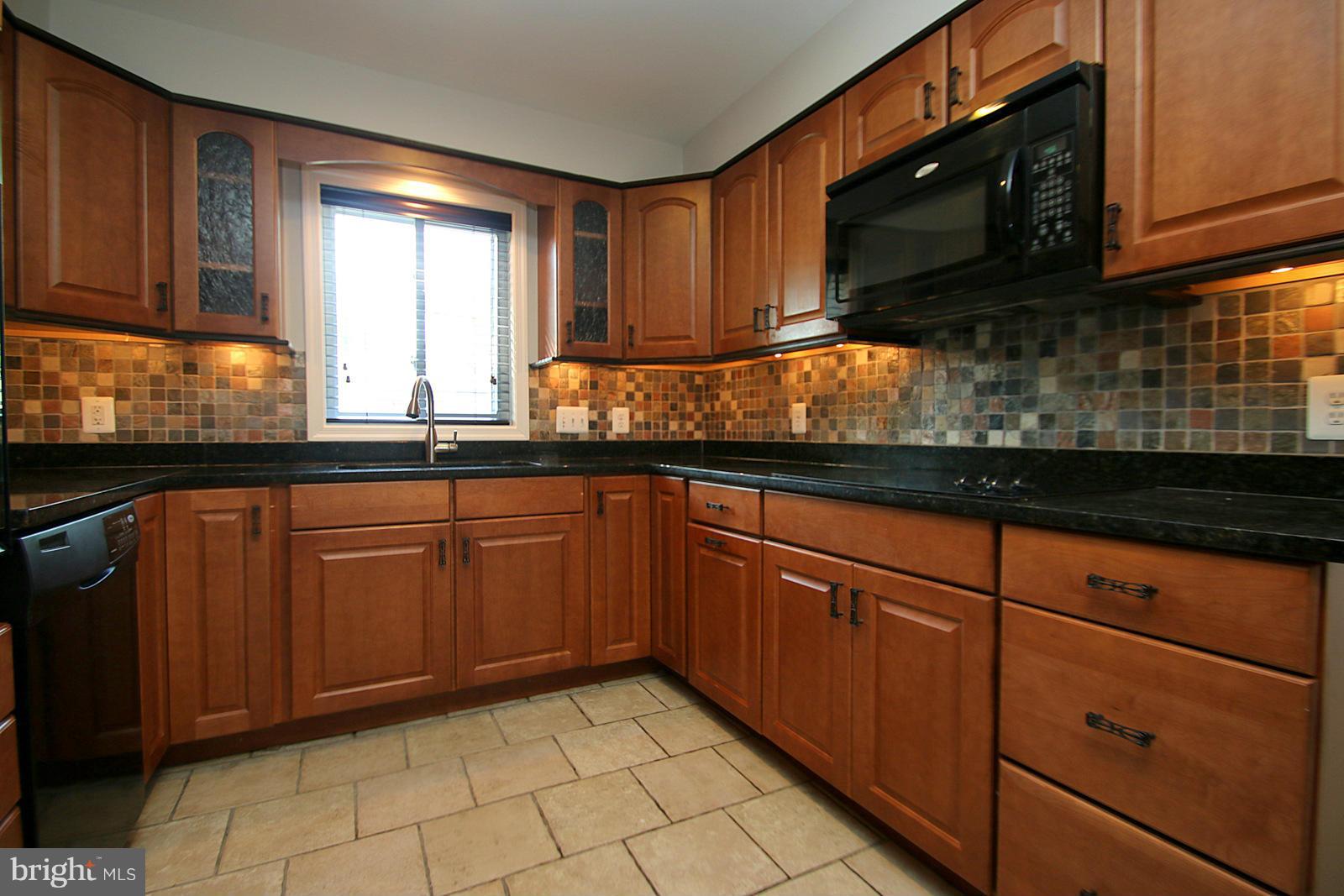 13205 Choptank Road Baltimore, MD 21220 - Photo 6 of 30 a kitchen with granite countertop cabinets stainless steel appliances a sink and a window