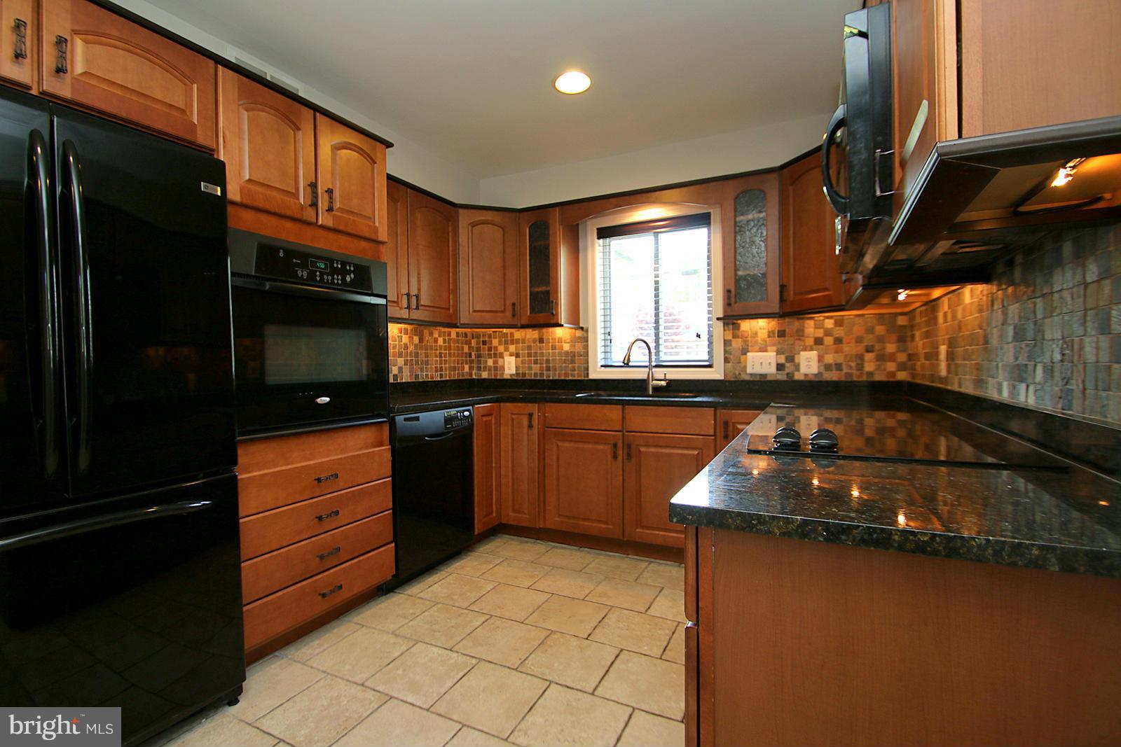 13205 Choptank Road Baltimore, MD 21220 - Photo 7 of 30 a kitchen with stainless steel appliances granite countertop a sink stove and cabinets