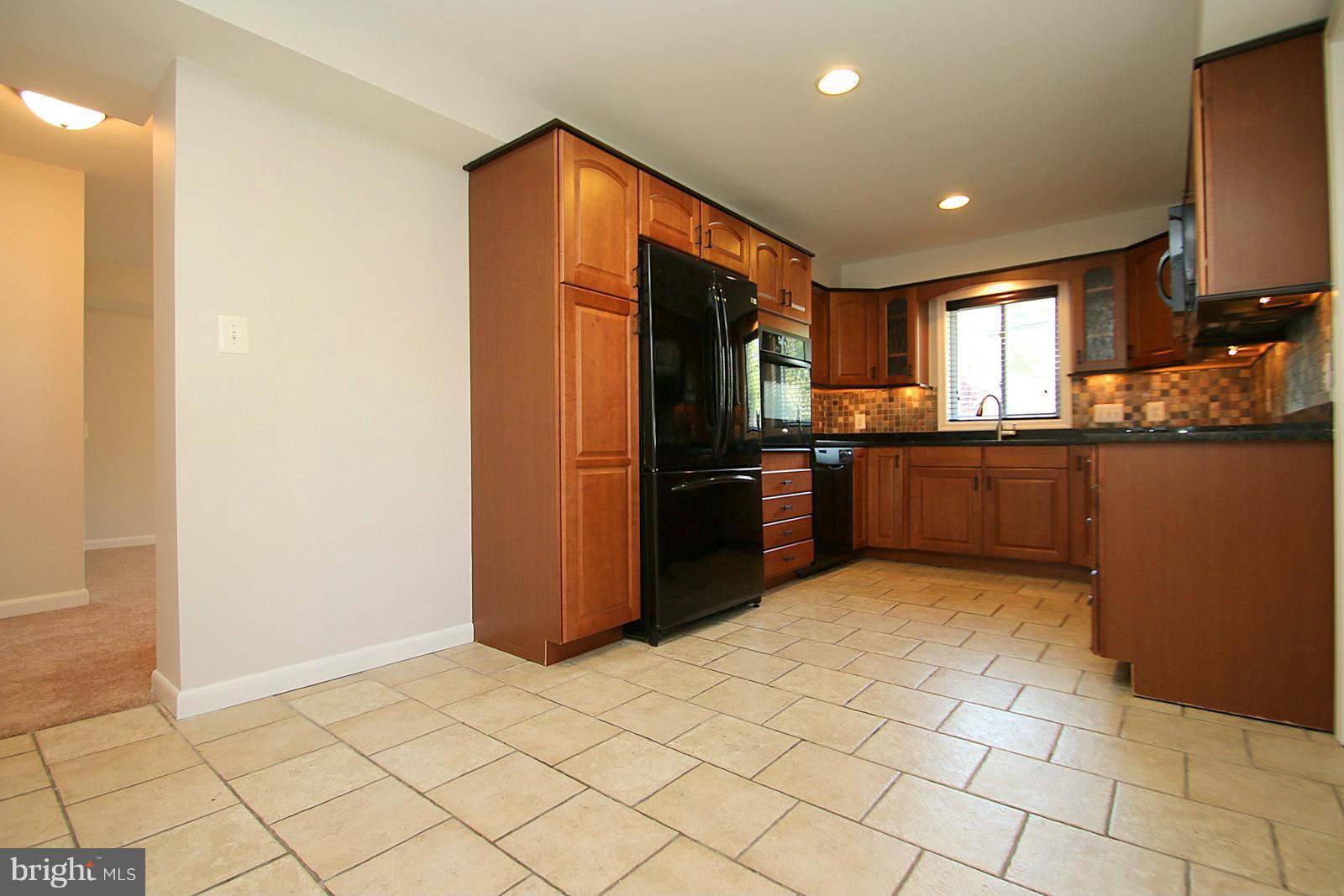 13205 Choptank Road Baltimore, MD 21220 - Photo 8 of 30 a kitchen with stainless steel appliances granite countertop a refrigerator and a stove top oven