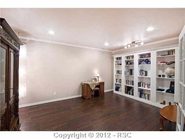 11468 Shaugnessy Road Colorado Springs, CO 80908 - Photo 13 of 16 Office with secret storage behind the bookcase.
