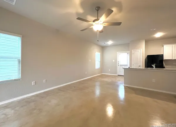 a view of a livingroom with a ceiling fan and window