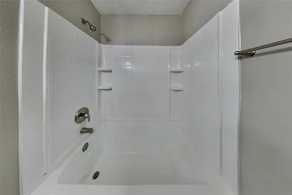 a bathroom with a shower and a bath tub