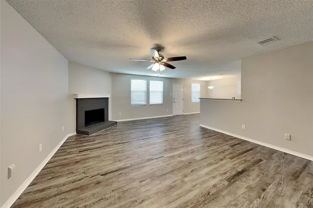 wooden floor in an empty room with a fireplace