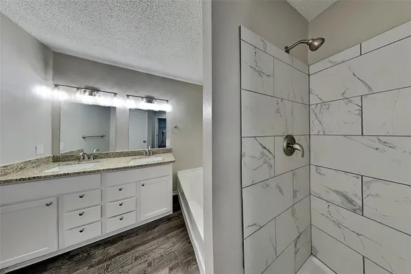 a bathroom with a double vanity sink and mirror