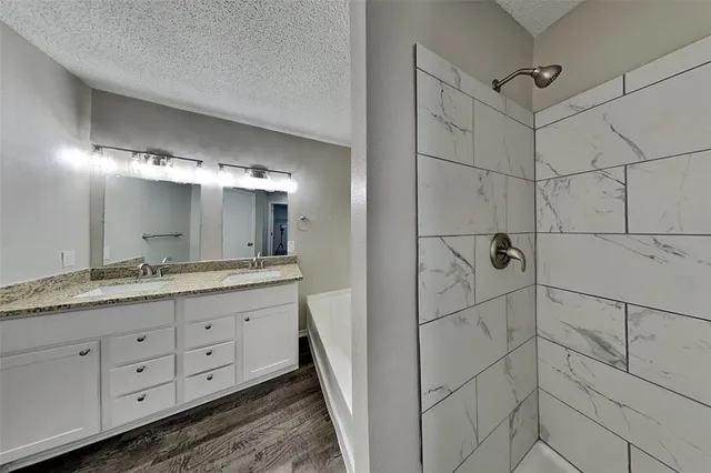 a bathroom with a double vanity sink and mirror