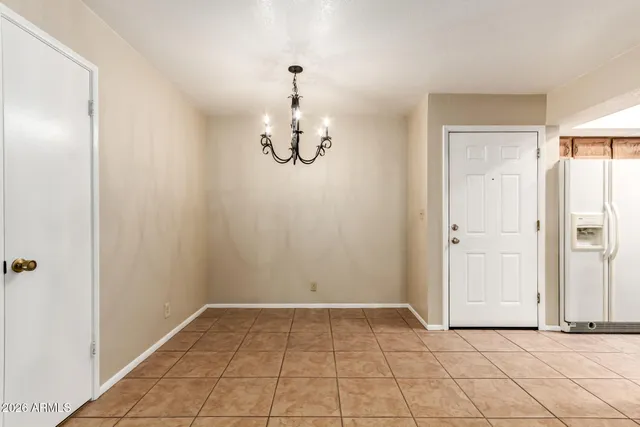 an empty room with kitchen view