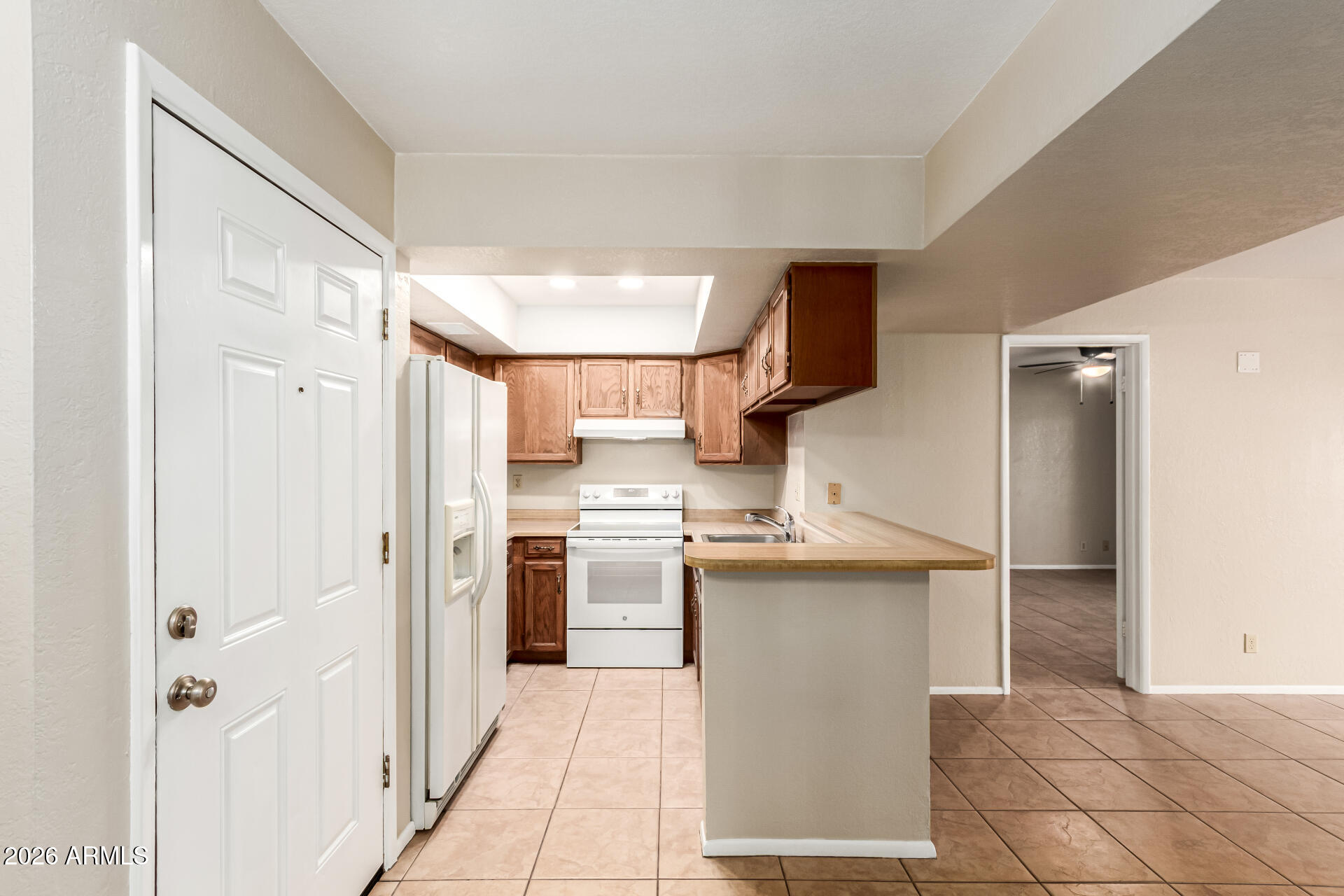 540 North May, Unit 3102 Mesa, AZ 85201 - Photo 13 of 45 a kitchen with stainless steel appliances granite countertop a refrigerator and a sink