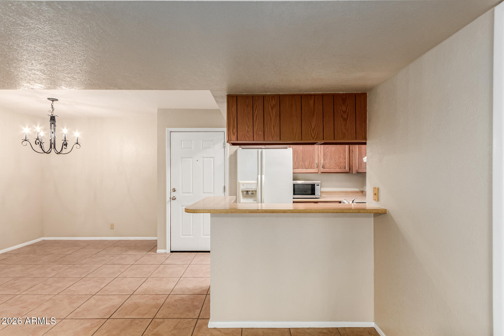 540 North May, Unit 3102 Mesa, AZ 85201 - Photo 14 of 45 a kitchen with stainless steel appliances granite countertop a refrigerator sink and cabinets