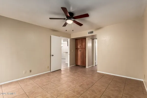 a view of an empty room with a ceiling fan