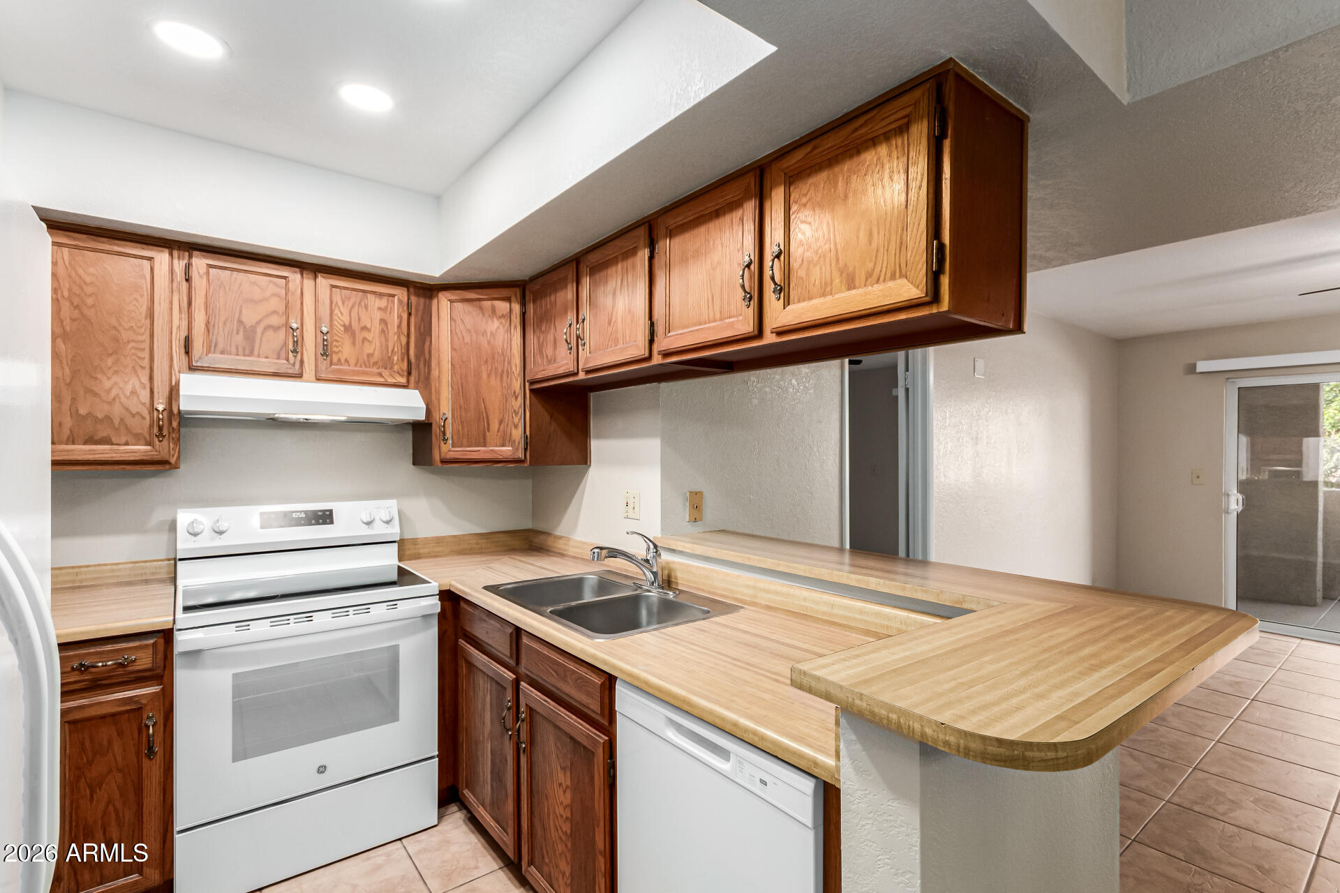 540 North May, Unit 3102 Mesa, AZ 85201 - Photo 2 of 45 a kitchen with a stove a sink and a refrigerator