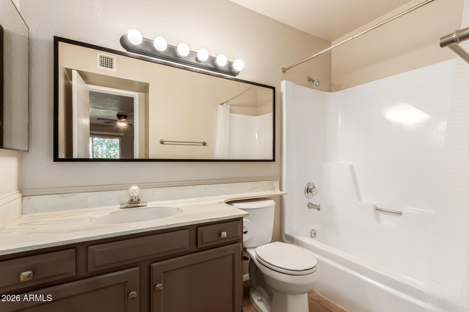 540 North May, Unit 3102 Mesa, AZ 85201 - Photo 22 of 45 a bathroom with a sink a toilet and a mirror