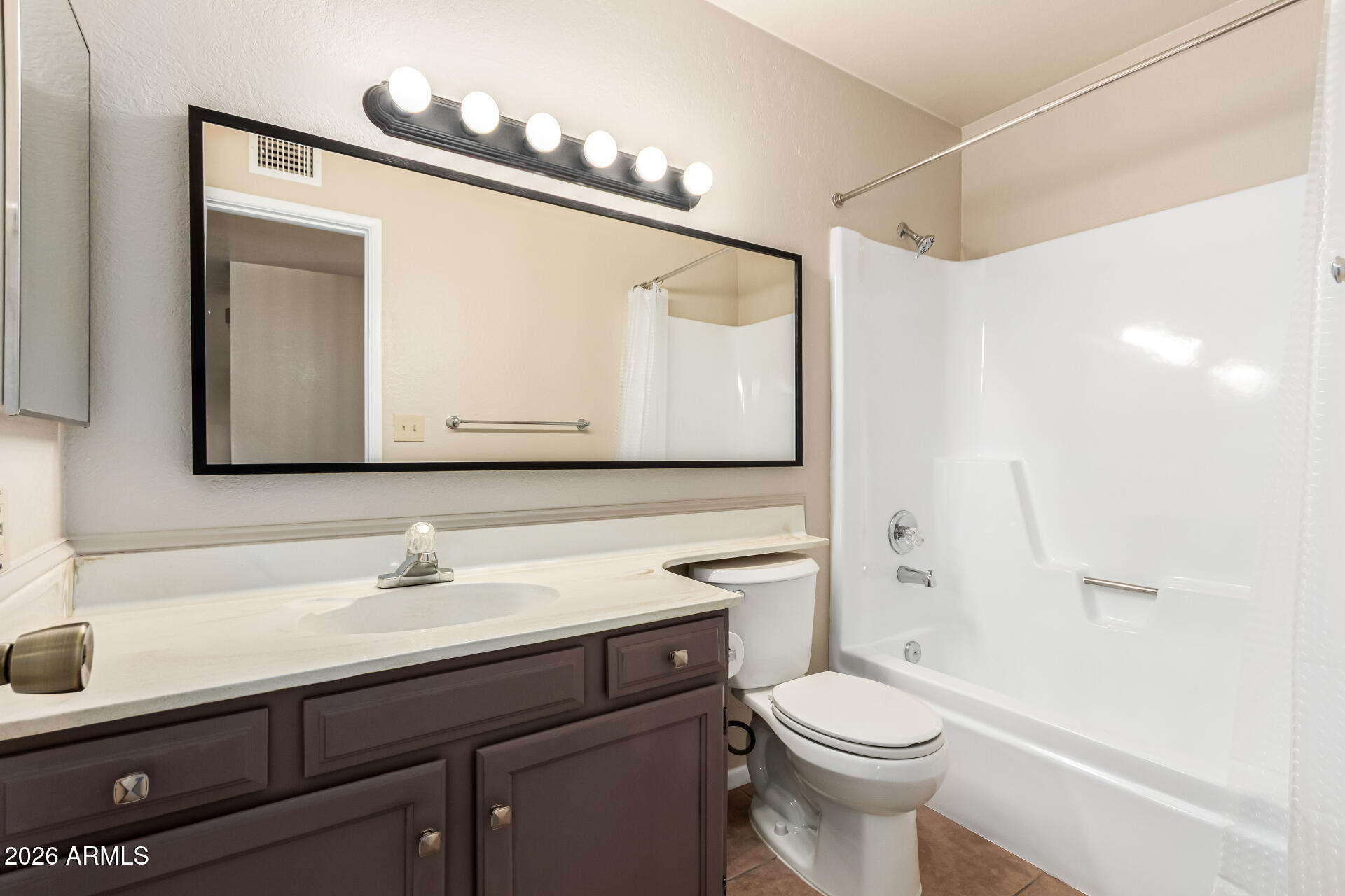 540 North May, Unit 3102 Mesa, AZ 85201 - Photo 26 of 45 a bathroom with a sink a toilet and shower a mirror