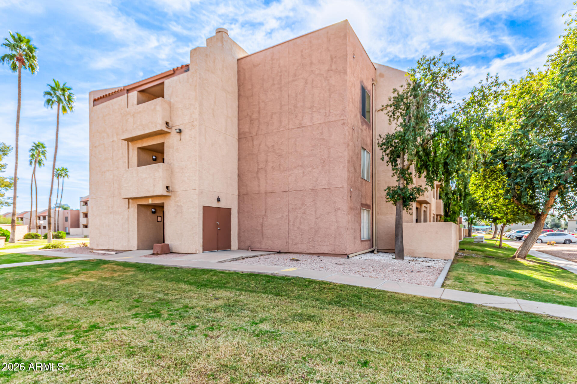 540 North May, Unit 3102 Mesa, AZ 85201 - Photo 4 of 45 a view of a backyard with potted plants and large tree