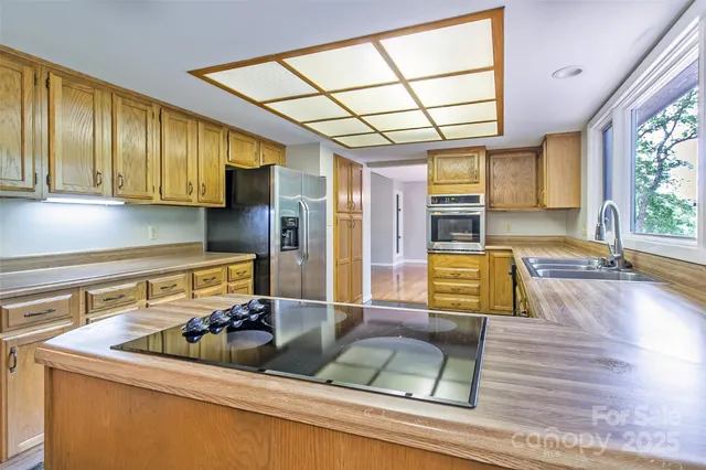 a kitchen with a sink and wooden cabinets
