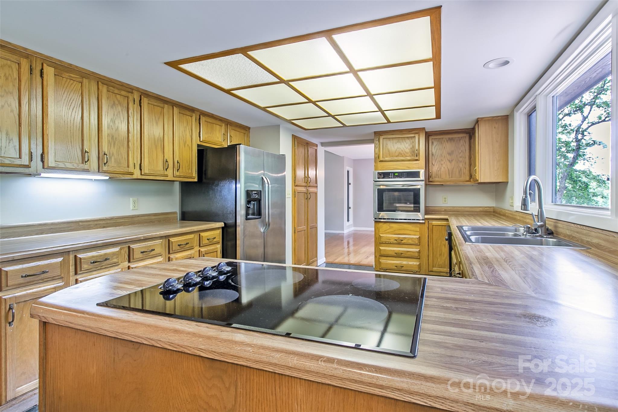 162 Southerland Road Pisgah Forest, NC 28768 - Photo 15 of 41 a kitchen with a sink and wooden cabinets