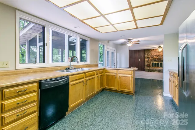 a large kitchen with a large window and stainless steel appliances