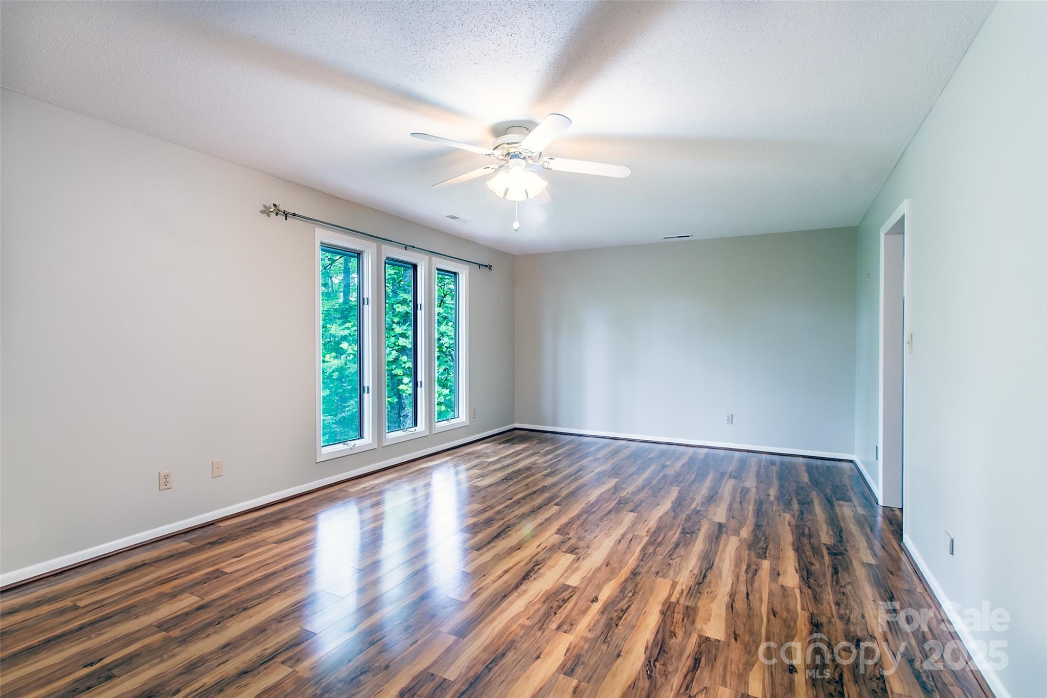162 Southerland Road Pisgah Forest, NC 28768 - Photo 23 of 41 wooden floor in an empty room with a window