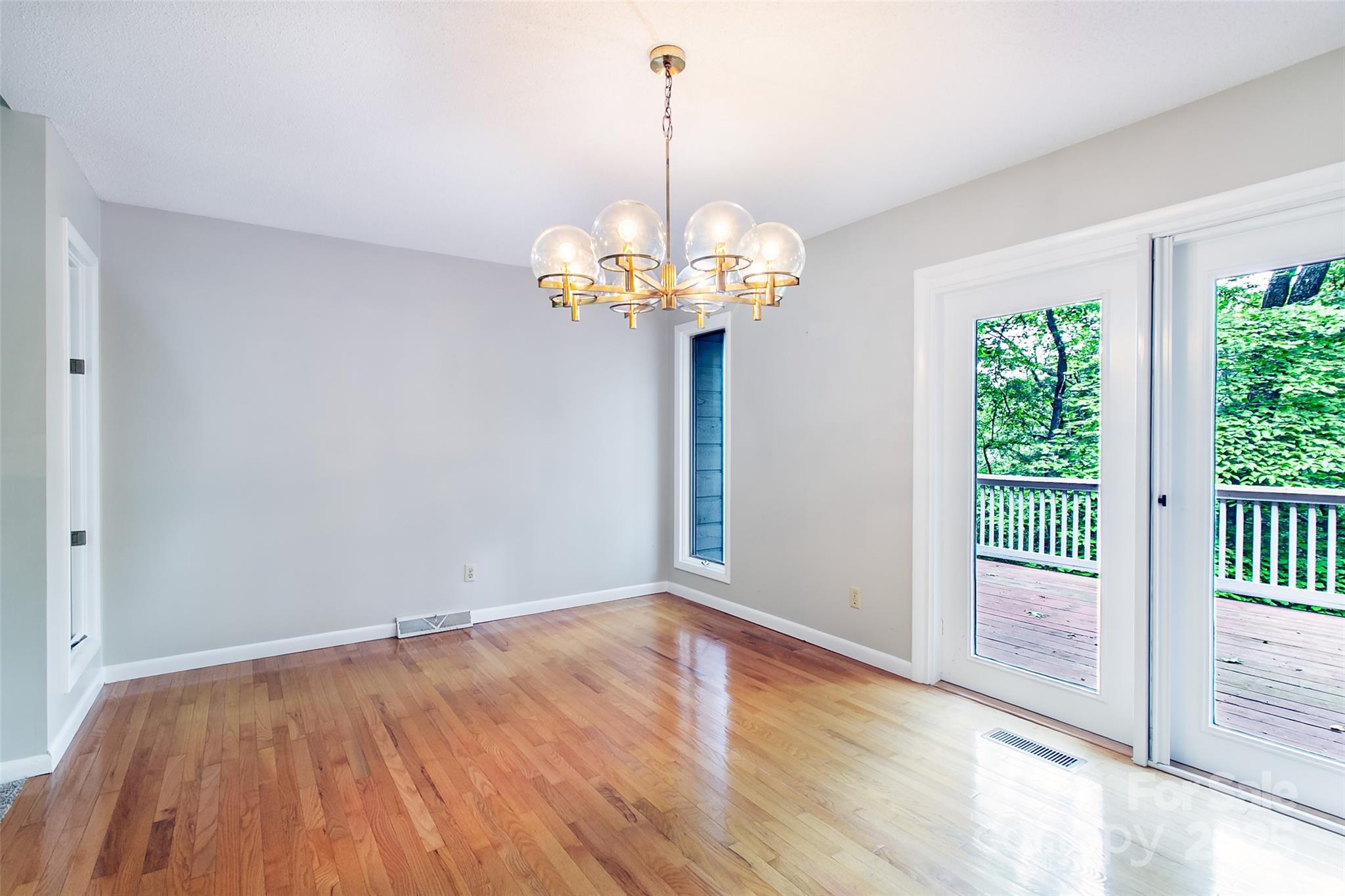 162 Southerland Road Pisgah Forest, NC 28768 - Photo 7 of 41 a view of an empty room with wooden floor and a window