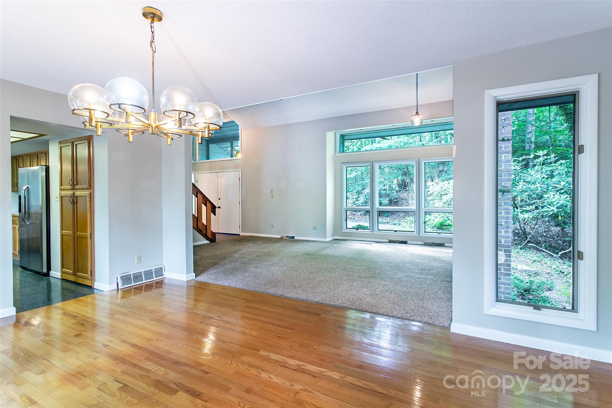 162 Southerland Road Pisgah Forest, NC 28768 - Photo 9 of 41 a view of a big room with wooden floor chandelier and windows