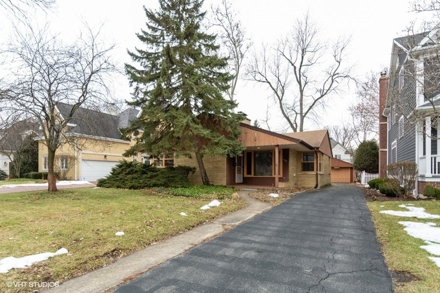 326 North County Line Road Hinsdale, IL 60521 - Photo 1 of 12 a front view of a house with a yard covered with snow and trees
