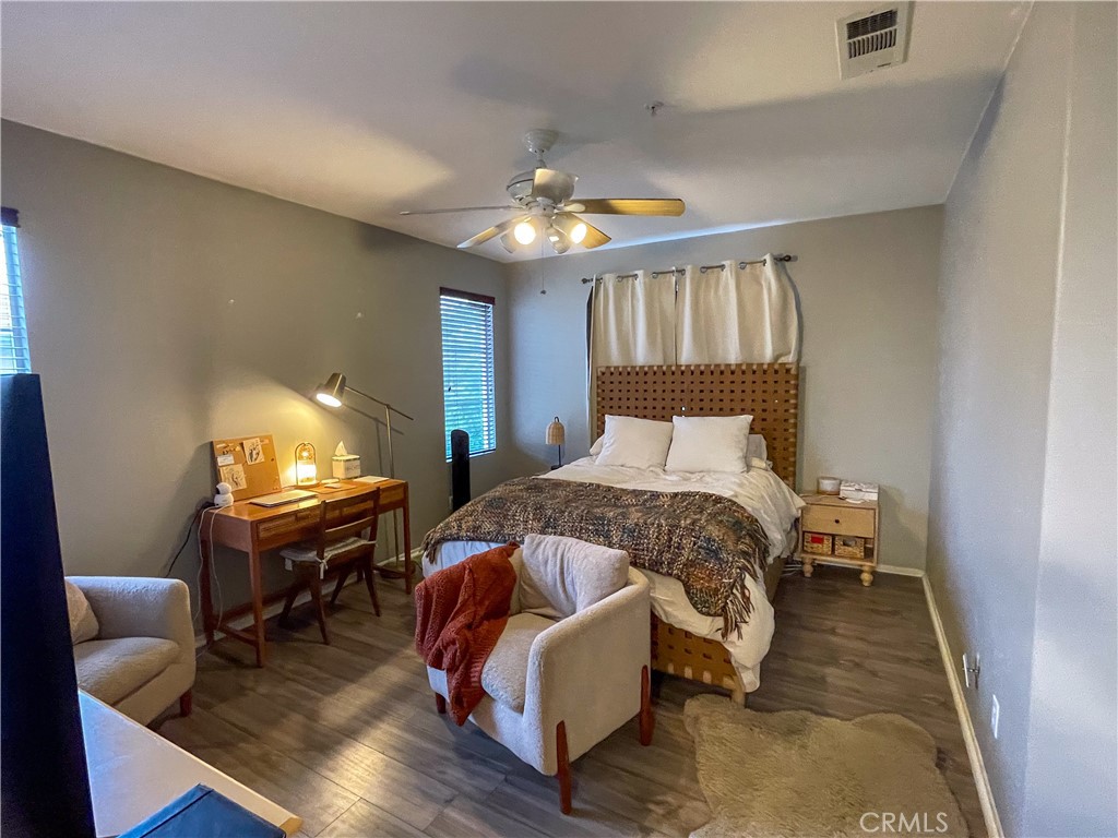 33570 Emerson Way, Unit C Temecula, CA 92592 - Photo 20 of 52 a bedroom with a bed and wooden floor