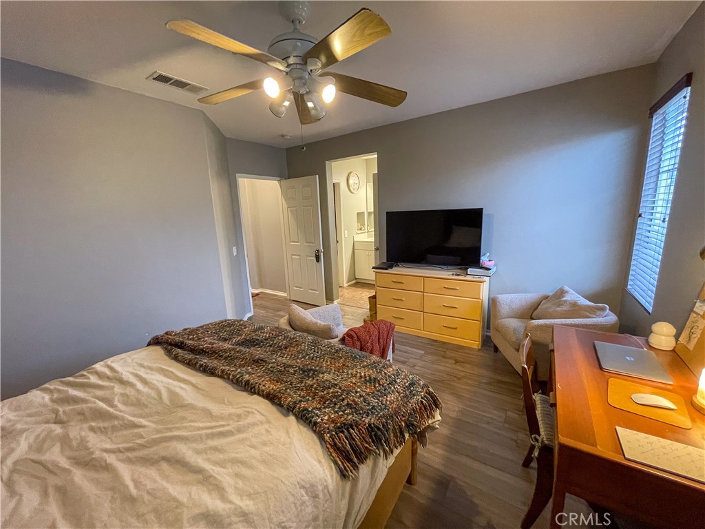 33570 Emerson Way, Unit C Temecula, CA 92592 - Photo 21 of 52 a bedroom with a bed and a flat screen tv