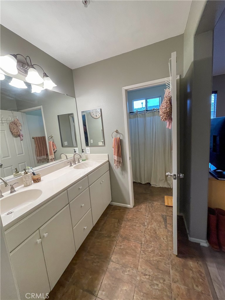 33570 Emerson Way, Unit C Temecula, CA 92592 - Photo 22 of 52 a spacious bathroom with a double vanity sink and a mirror