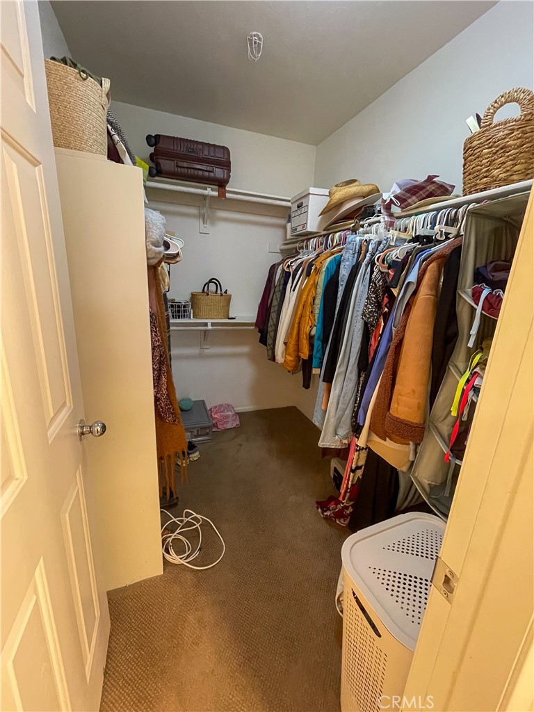 33570 Emerson Way, Unit C Temecula, CA 92592 - Photo 24 of 52 a view of walk in closet with clothes and shoes