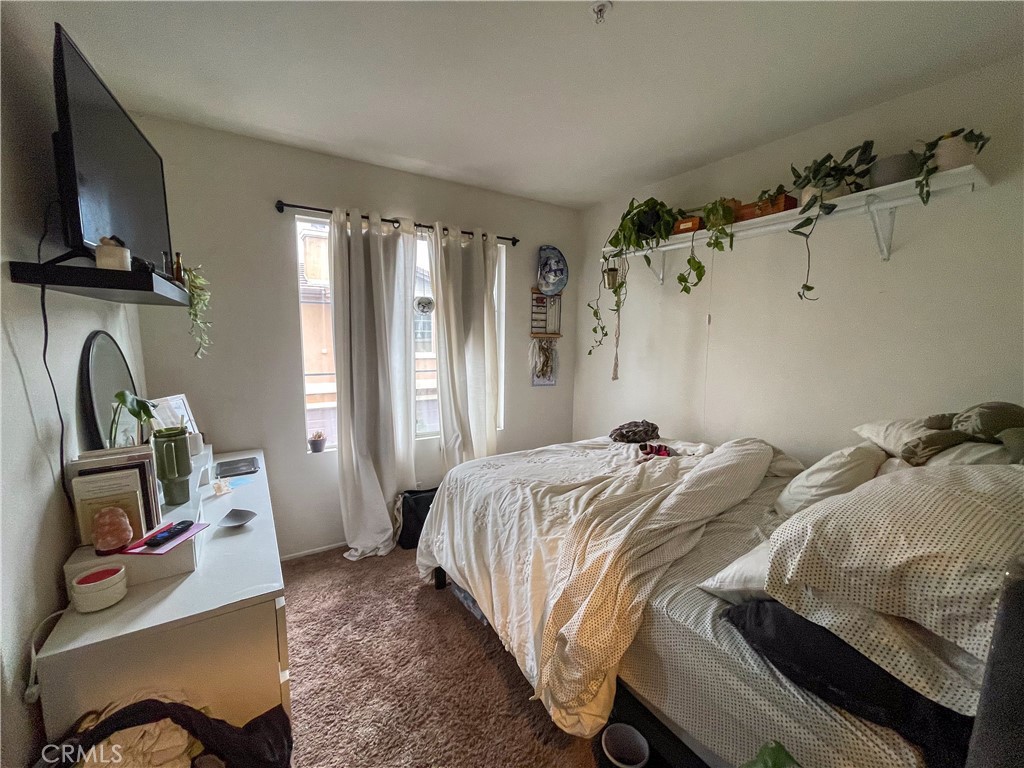 33570 Emerson Way, Unit C Temecula, CA 92592 - Photo 26 of 52 a bedroom with a bed and a flat tv screen on a dresser