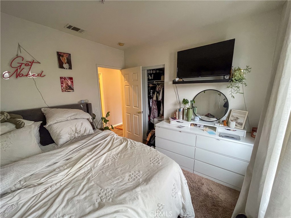 33570 Emerson Way, Unit C Temecula, CA 92592 - Photo 27 of 52 a bedroom with a bed and a flat screen tv