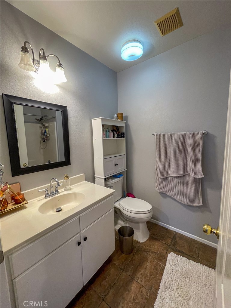 33570 Emerson Way, Unit C Temecula, CA 92592 - Photo 28 of 52 a bathroom with a toilet sink and mirror