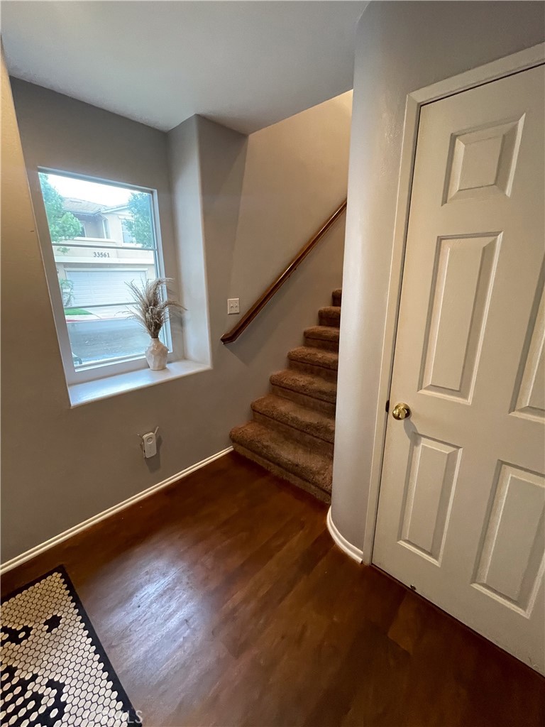 33570 Emerson Way, Unit C Temecula, CA 92592 - Photo 7 of 52 a view of an empty room with wooden floor and stairs