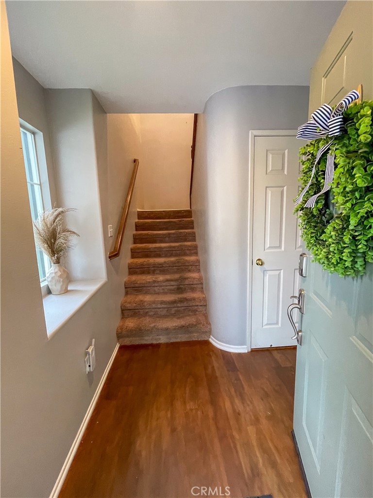 33570 Emerson Way, Unit C Temecula, CA 92592 - Photo 8 of 52 a view of entryway and hall with wooden floor