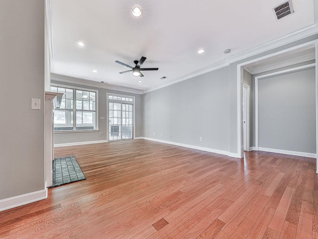 626 Laurel Crossing Canton, GA 30114 - Photo 16 of 77 a view of an empty room with a window and wooden floor