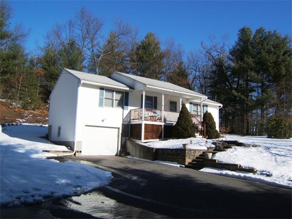 203 Fitch Road Clinton, MA 01510 - Photo 23 of 29 a view of a white house with a yard covered in snow