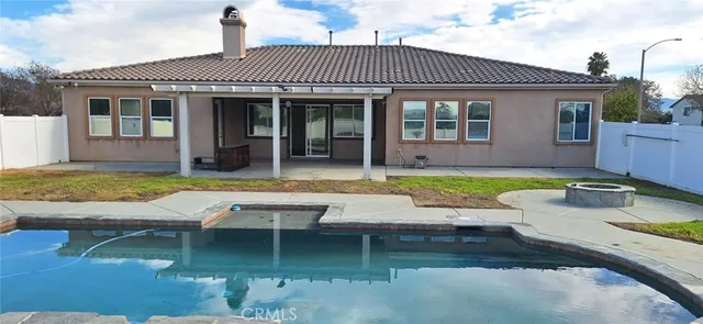a view of a house with swimming pool and sitting area
