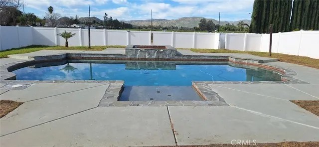 a view of a swimming pool with a lounge chair