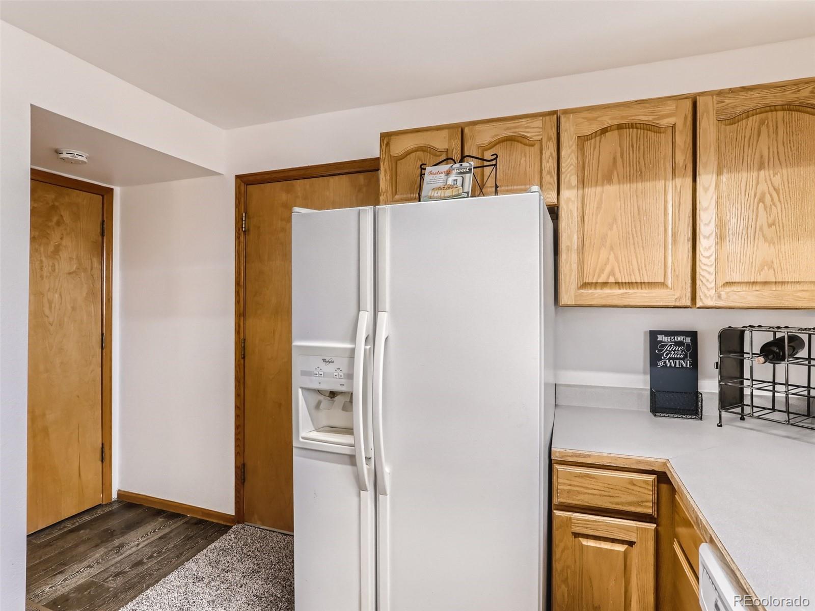4399 Perth Circle Denver, CO 80249 - Photo 11 of 30 a white refrigerator freezer sitting in a kitchen