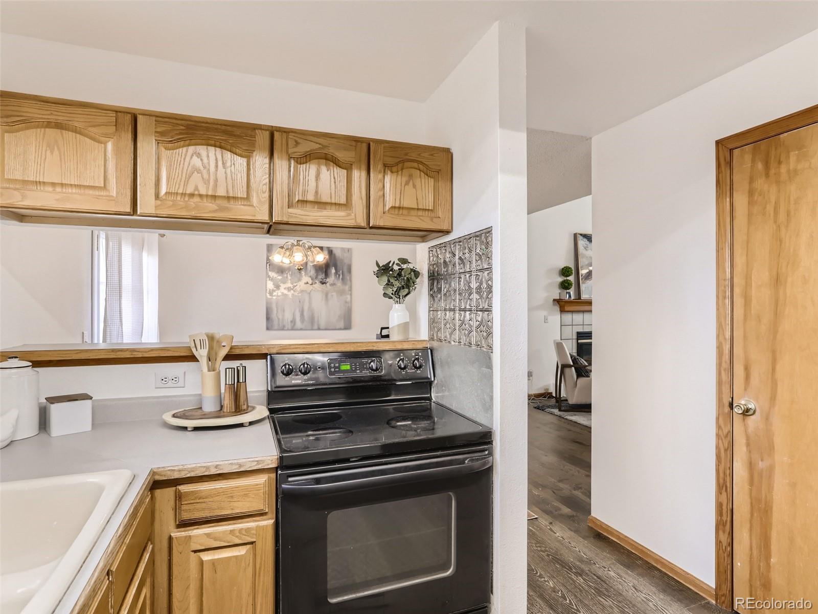4399 Perth Circle Denver, CO 80249 - Photo 14 of 30 a kitchen with stainless steel appliances granite countertop a stove and a refrigerator