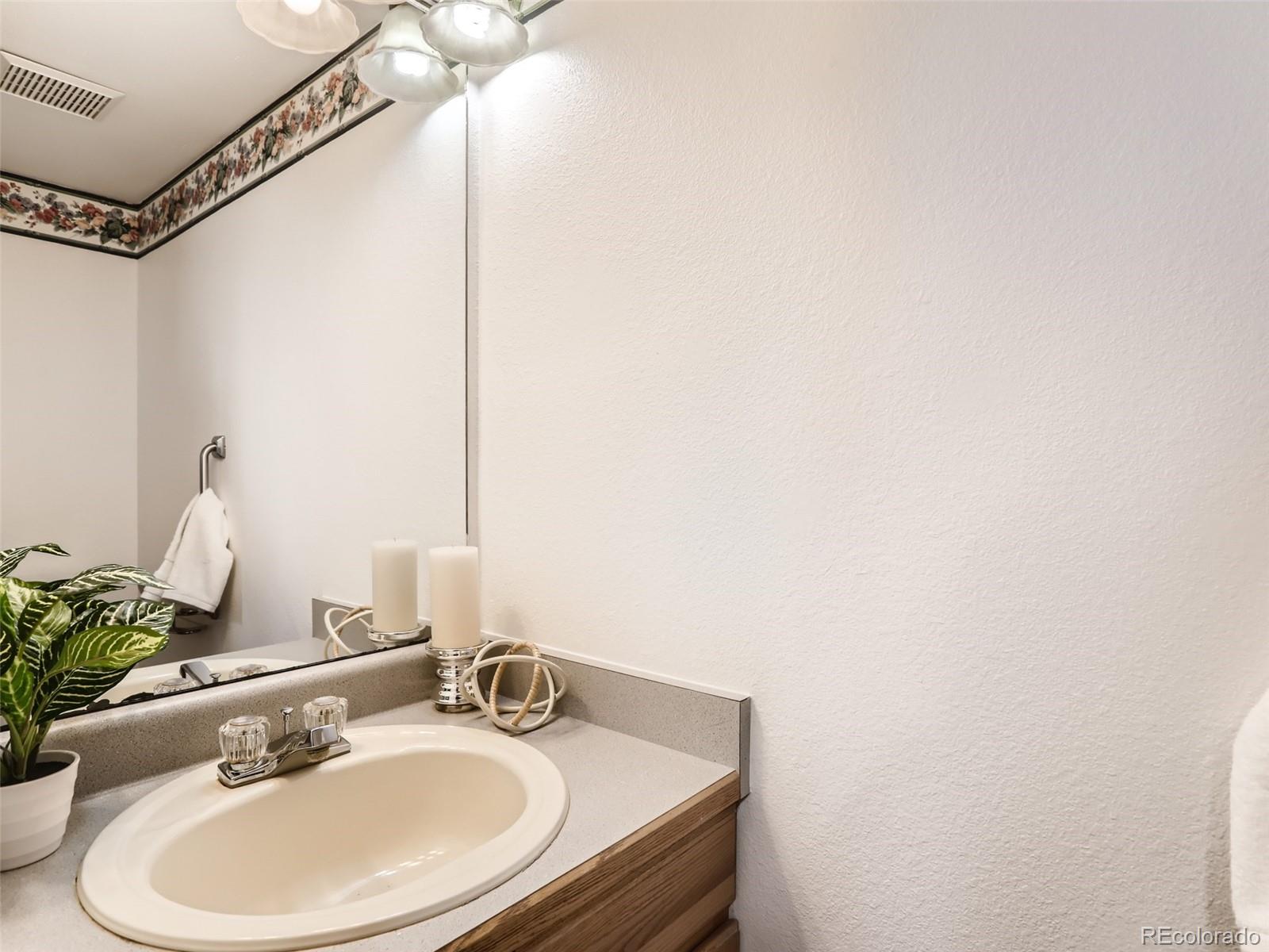 4399 Perth Circle Denver, CO 80249 - Photo 15 of 30 a bathroom with a sink and a mirror