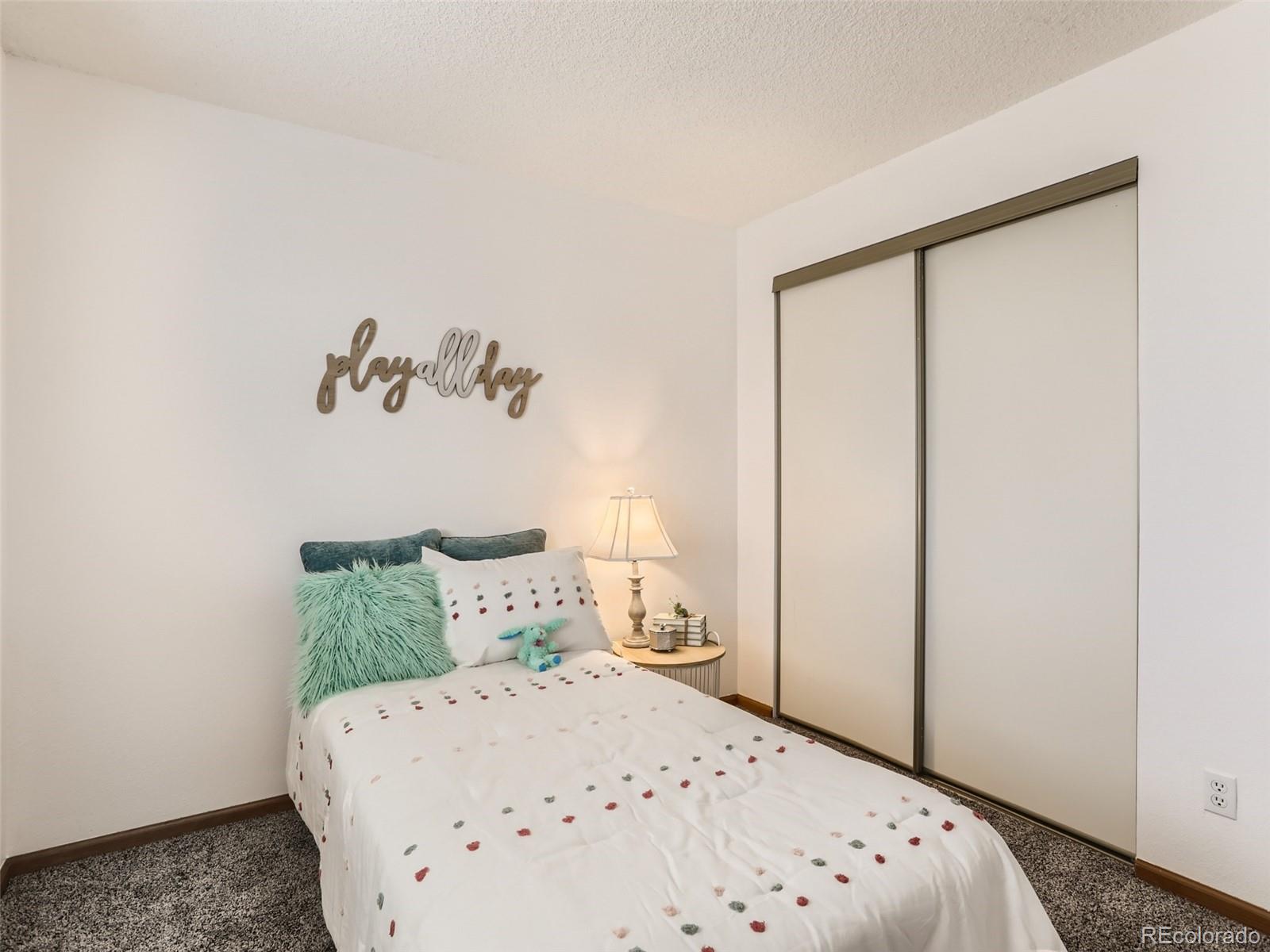 4399 Perth Circle Denver, CO 80249 - Photo 22 of 30 a bedroom with a bed and a window