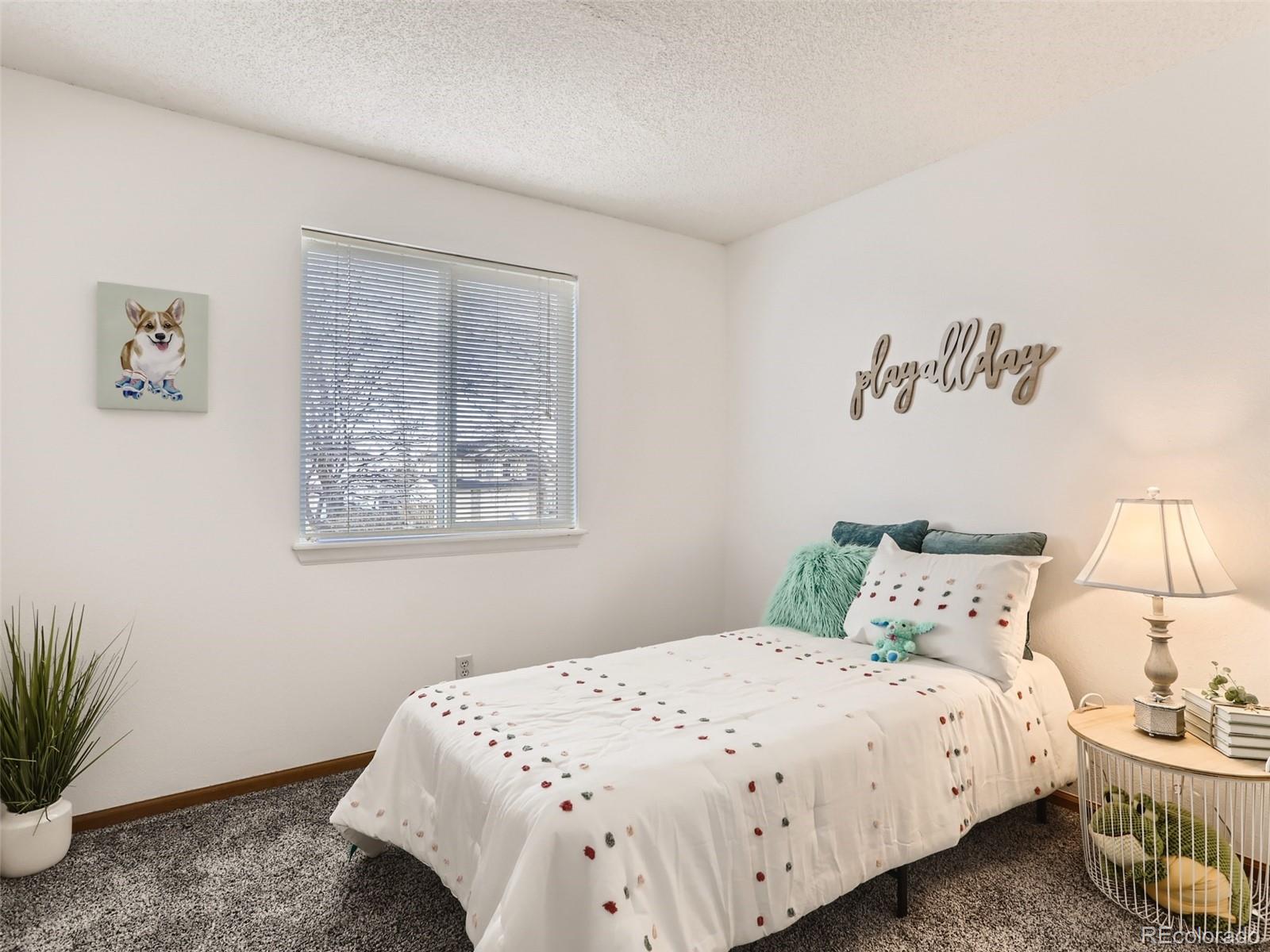 4399 Perth Circle Denver, CO 80249 - Photo 23 of 30 a bedroom with a bed and a potted plant