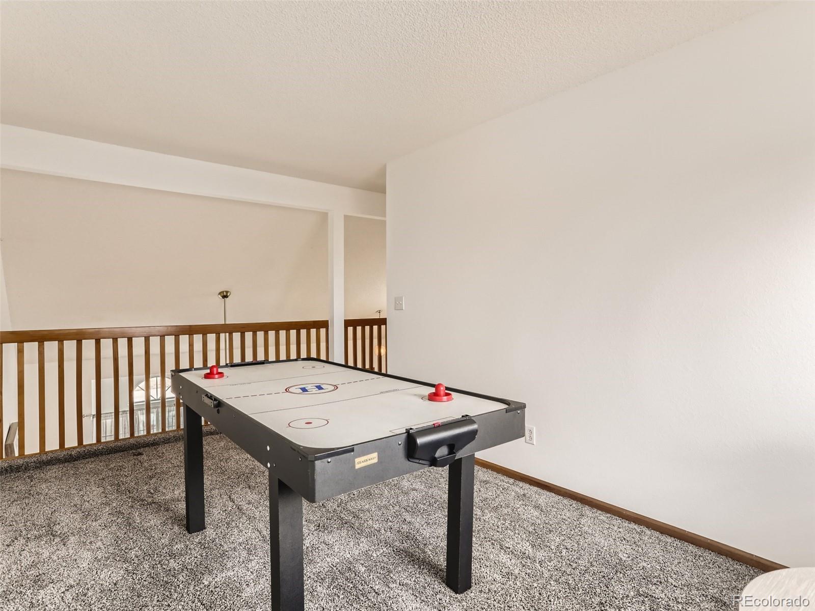 4399 Perth Circle Denver, CO 80249 - Photo 24 of 30 a view of a hallway with a table and chairs